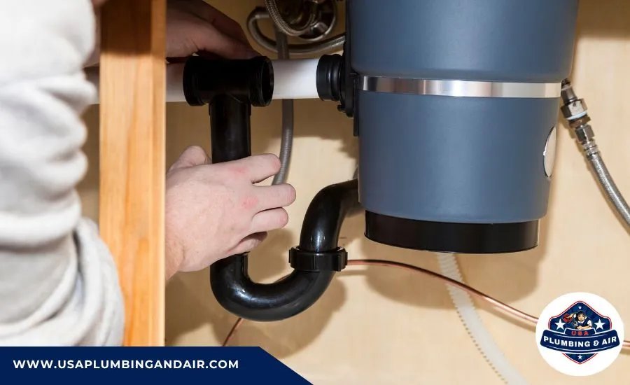 Professional plumber performing garbage disposal repair in Las Vegas NV