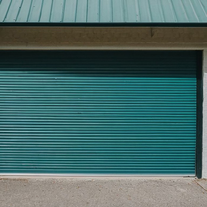 Technician performing garage door balance and alignment check